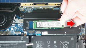 Unscrew and slide out the M.2 NVMe SSD/a