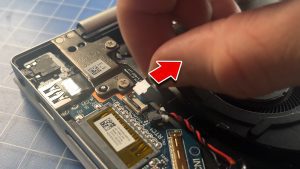 Unclip the locking tab and disconnect the I/O board cable.