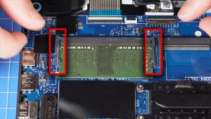 Pull the locking tabs outwardly away from the RAM to release them.