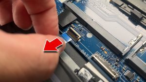 Unclip the locking tab and disconnect the touchpad cable.