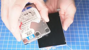 Unscrew and separate the Hard Drive from the caddy.