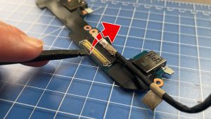 Unclip the locking tab and disconnect the I/O board cable.