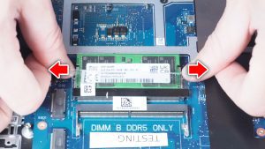 Pry the locking tabs outward to release the RAM from DIMM slot A.