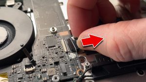 Unclip the locking tab and then disconnect the touchpad cable.