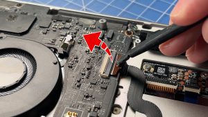 Unclip the locking tab and then disconnect the touchpad cable.