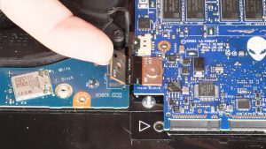 Unscrew and disconnect the I/O board cable that bridges the left I/O circuit board to the motherboard (1 x M2 x 3mm wafer).