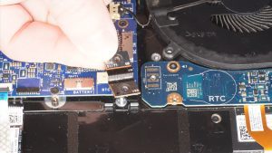 Unscrew and disconnect the I/O board cable that bridges the right I/O circuit board to the motherboard (2 x M2 x 3mm wafer).