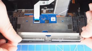 Unscrew and remove the bracket and Touchpad (6 x M2 x 2mm).